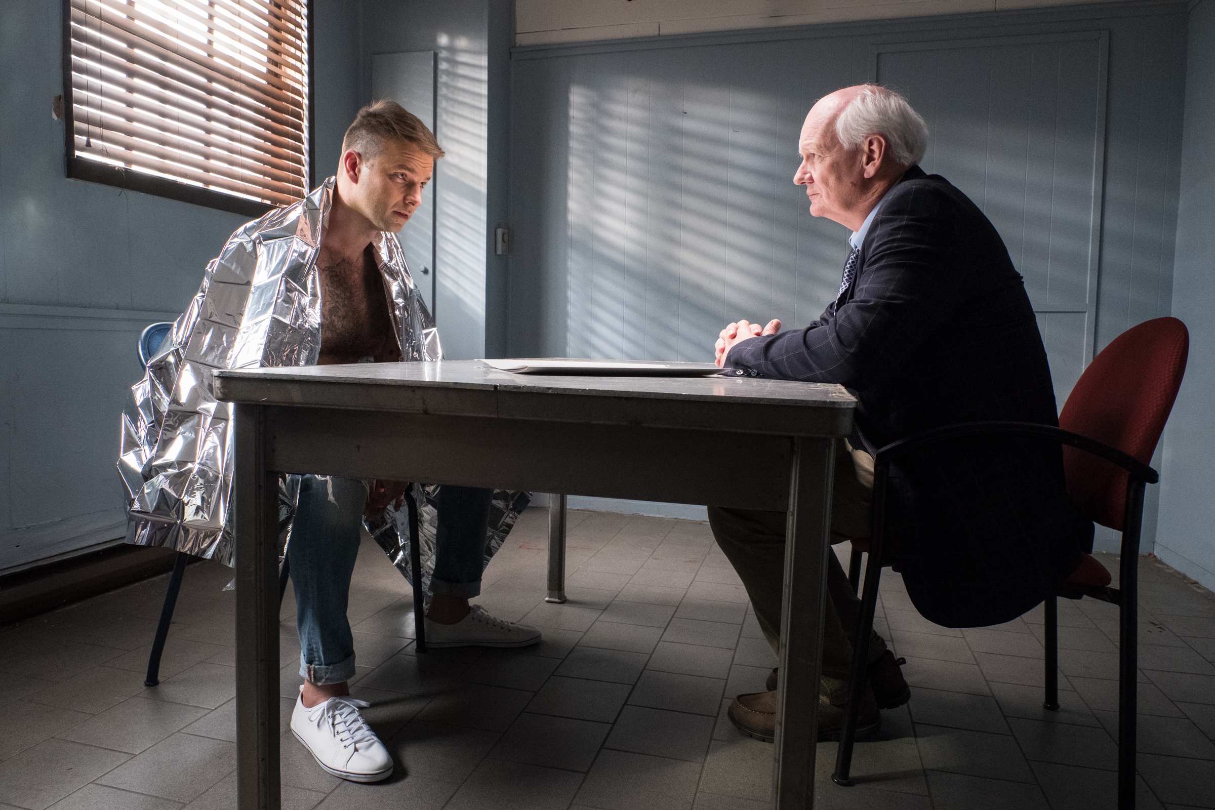 Sean Chase faces Detective Morton in the interrogation room